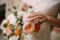 Bride holds a bouquet of multi-colored peonies in her hands. Close-up Royalty Free Stock Photo