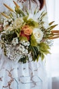 Bride holds a bouquet of roses and lilies Royalty Free Stock Photo