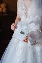 Bride holds an envelope sealed with white sealing wax