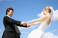 Bride holds fiance for hands