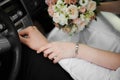 The bride holds the hand of the groom in the car, closeup shot Royalty Free Stock Photo