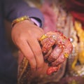 The bride holds her groom`s finger at the wedding ceremony.