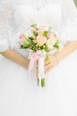 The bride holds a wedding bouquet in her hands. Bouquet of white and pink roses. Royalty Free Stock Photo