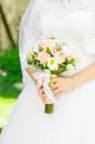 The bride holds a wedding bouquet in her hands. Bouquet of white and pink roses. Royalty Free Stock Photo