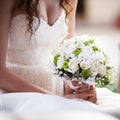 Bride holds wedding bouquet.