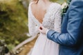 Groom and bride. Bride holds a wedding bouquet. Wedding dress, wedding details. Royalty Free Stock Photo