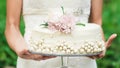 Bride holds a wedding cake Royalty Free Stock Photo