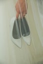 The bride holds wedding shoes in her hands Royalty Free Stock Photo