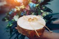 Bride holds wooden stand with golden wedding rings. A touching moment at the ceremony. Rings on round wooden stand, close up Royalty Free Stock Photo