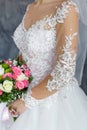 Bride in a lace dress holding a wedding bouquet of white and pink roses Royalty Free Stock Photo