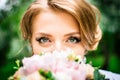 Bride with large green eyes looks into the camera Royalty Free Stock Photo