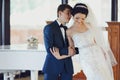 Bride leans on a groom's shoulder standing in the front of a pia Royalty Free Stock Photo