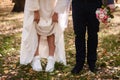 the bride lifted her skirt, showing white sneakers. Royalty Free Stock Photo
