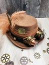 bride light brown steampunk hat with brown veil ribbon, feather, goggles, gears,