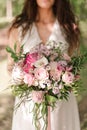 bride with long hair in a white dress is holding a bridal bouquet. wedding Royalty Free Stock Photo