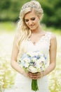 Bride looking at bouquet Royalty Free Stock Photo