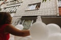 bride looking from window at bridesmaid with bunch of white decorative baloons, balloons wedding decor closeup