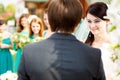 Bride looks charmed listening to the groom's oath Royalty Free Stock Photo