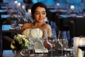 Bride looks happy sitting in an empty restaurant