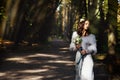 Bride looks sensual holding a lily bouquet