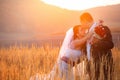 Bride looks up at a groom while he kisses her forehead delicately