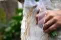 Bride with a modern gold bracelet, wedding ring and solitaire ring on her wrist,  holding elegant modern autumn wedding bouquet. Royalty Free Stock Photo