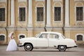 Bride near white vintage car Royalty Free Stock Photo