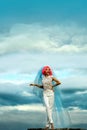 Bride with orange hair on blue sky