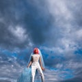 Bride with orange hair on blue sky