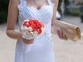 Bride with bouquet and reticule walking on street