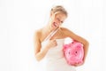 Bride with piggy bank showing thumbs up