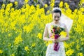 Bride portraint with white wedding dress in cole flower field Royalty Free Stock Photo