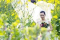 Bride portraint with white wedding dress in cole flower field Royalty Free Stock Photo