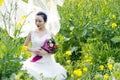 Bride portraint with white wedding dress in cole flower field Royalty Free Stock Photo