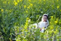 Bride portraint with white wedding dress in cole flower field Royalty Free Stock Photo