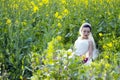 Bride portraint with white wedding dress in cole flower field Royalty Free Stock Photo