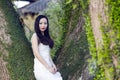 Bride portraint with white wedding dress in front of Old trees and old building