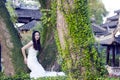 Bride portraint with white wedding dress in front of Old trees and old building