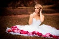Bride portrait in white bridal veiling with artificial bunch photo session, leaves and trees background, summer weather, fashion