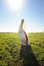 Bride posing outdoor on a green field Royalty Free Stock Photo