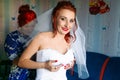 Bride is preparing for the wedding. bridesmaid helps the girl to put on her dress. Royalty Free Stock Photo