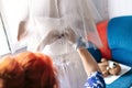 Bride is preparing for the wedding. bridesmaid helps the girl to put on her dress. Royalty Free Stock Photo