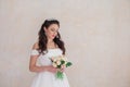 Bride Princess stands in a wedding dress with flowers