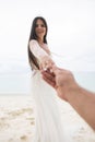 The bride pulls the hand of her fiance. A first-person view of a man