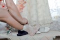 The bride pulls the legs white socks.