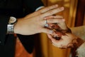 A Bride put on a ring Gold Wedding Rings on Her Husband their hand Royalty Free Stock Photo