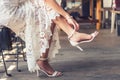 Bride put on wedding shoes on her feet Royalty Free Stock Photo