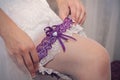 The bride puts a garter on her leg