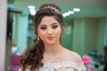 The bride puts her hand on her shoulder and takes a picture at the wedding. Wedding photo session in a beauty salon . Azerbaijan