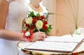 Bride puts signature in registry office. Royalty Free Stock Photo